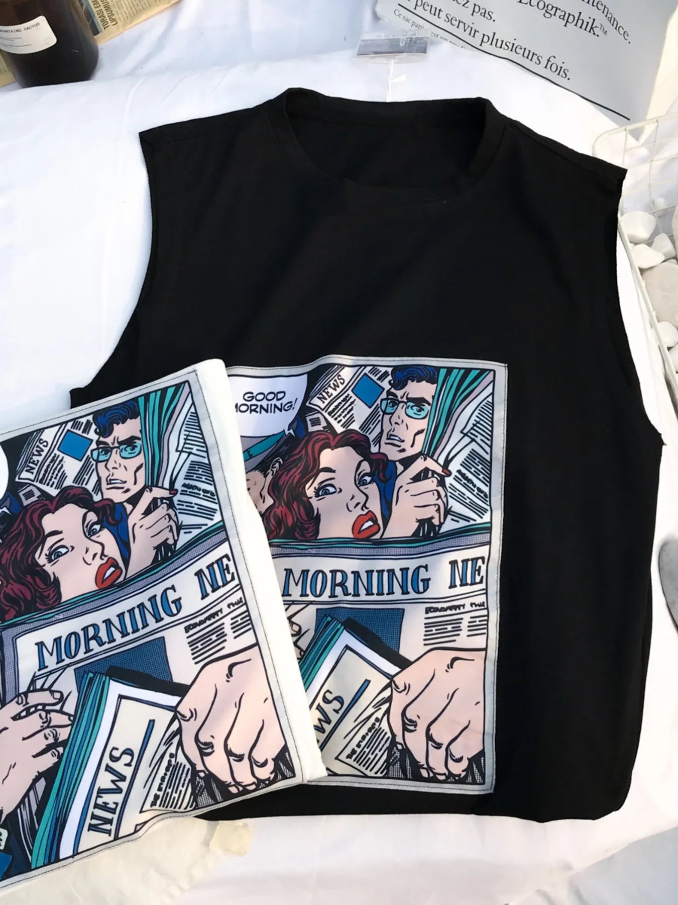 Close-up detail of the URBAN UNIT Morning News Graphic Tank in Midnight Black, highlighting the vintage comic print and durable fabric for the urban grind.