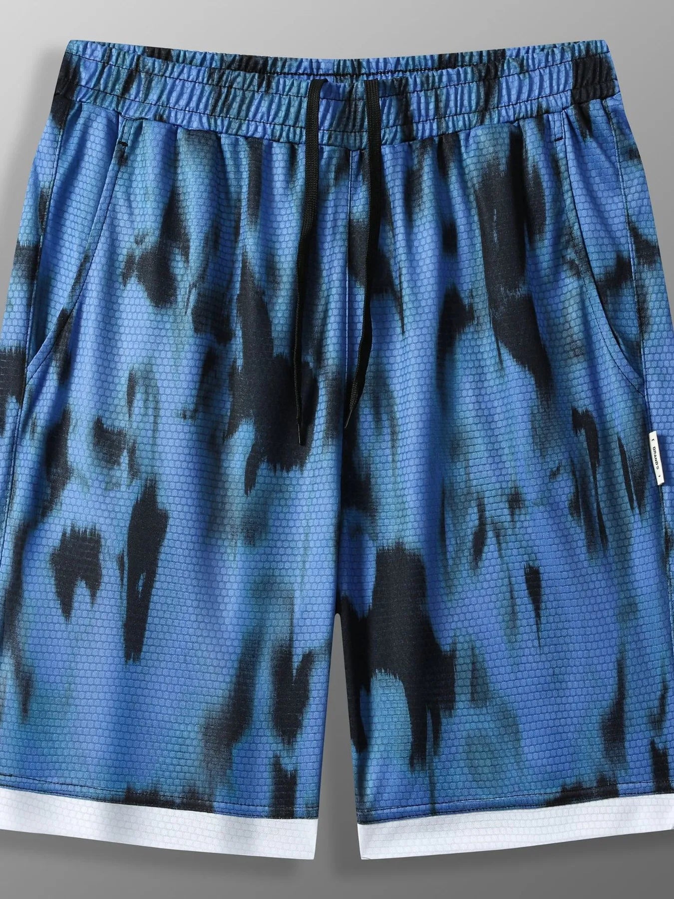 URBAN UNIT SHIFT Tie-Dye Active Shorts in Midnight Blue Distortion - Front view showcasing oversized fit and high-contrast hem.