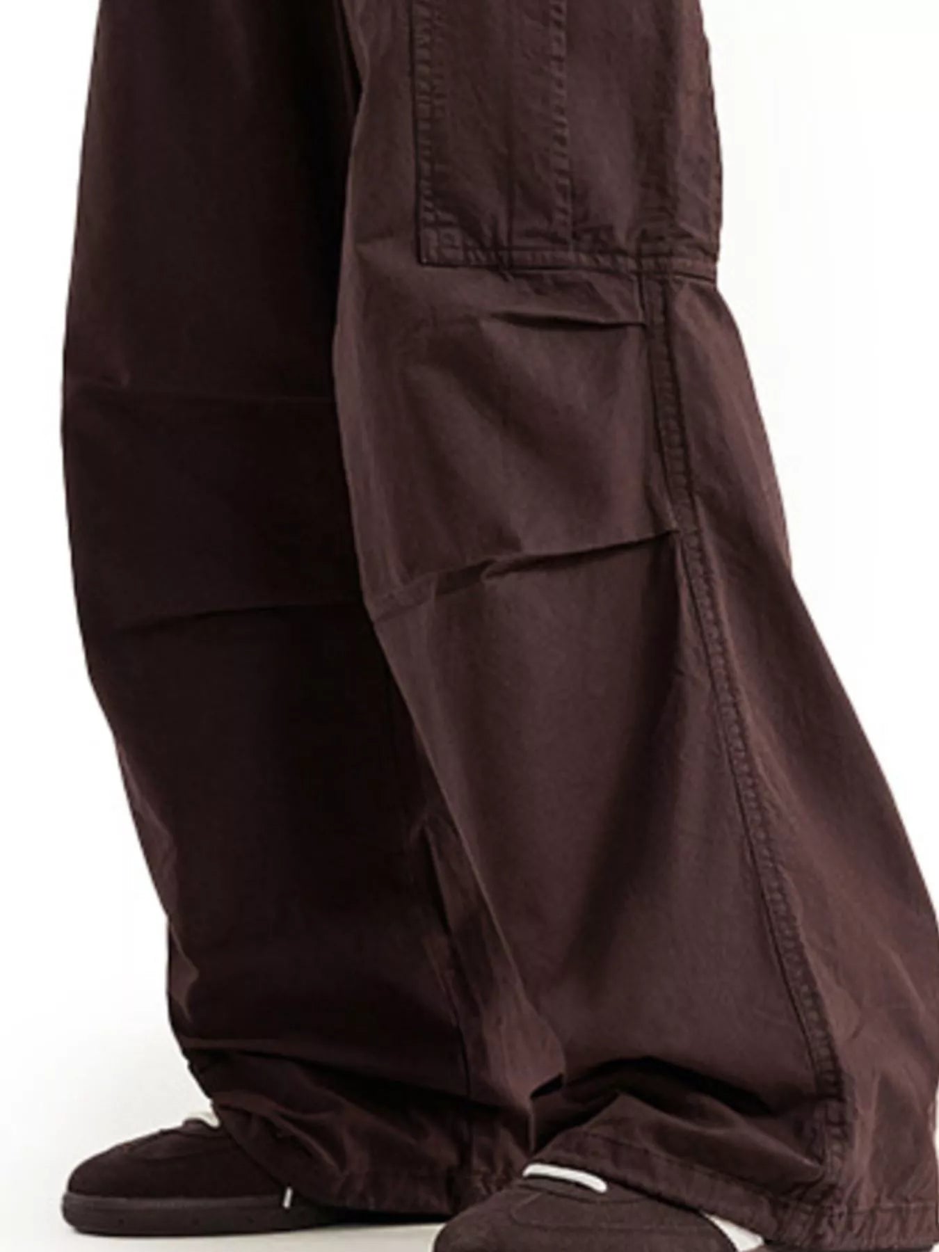 URBAN UNIT // Architect Kinetic Cargo in Earth Umber - Close-up of the technical knee-articulation pleats and reinforced fabric texture for maximum urban utility.