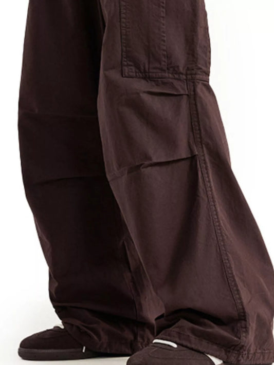 URBAN UNIT // Architect Kinetic Cargo in Earth Umber - Close-up of the technical knee-articulation pleats and reinforced fabric texture for maximum urban utility.