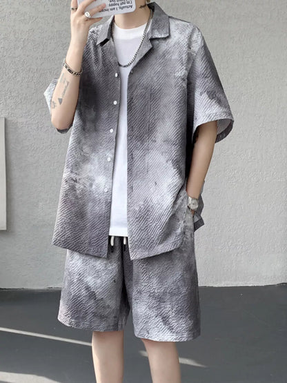 URBAN UNIT Corrosion Tie-Dye Set in Concrete Ash. A raw, desaturated grey gradient on a structured two-piece set. Find your freedom in the urban jungle.