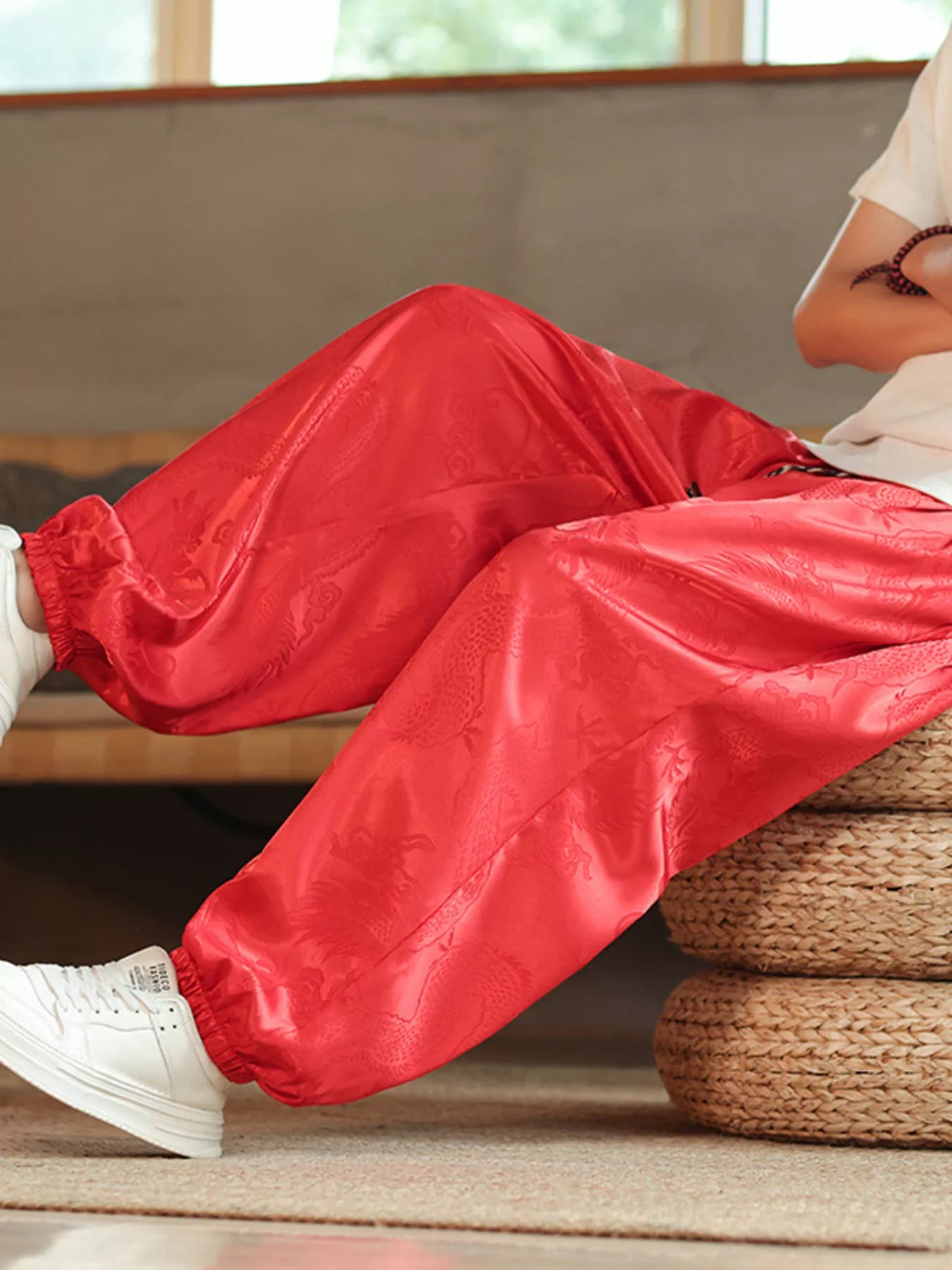Close-up of URBAN UNIT Dynasty Silhouette Jacquard Harem Pants in Blood Red, highlighting the premium silk-feel fabric and intricate heritage design.