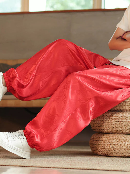 Close-up of URBAN UNIT Dynasty Silhouette Jacquard Harem Pants in Blood Red, highlighting the premium silk-feel fabric and intricate heritage design.