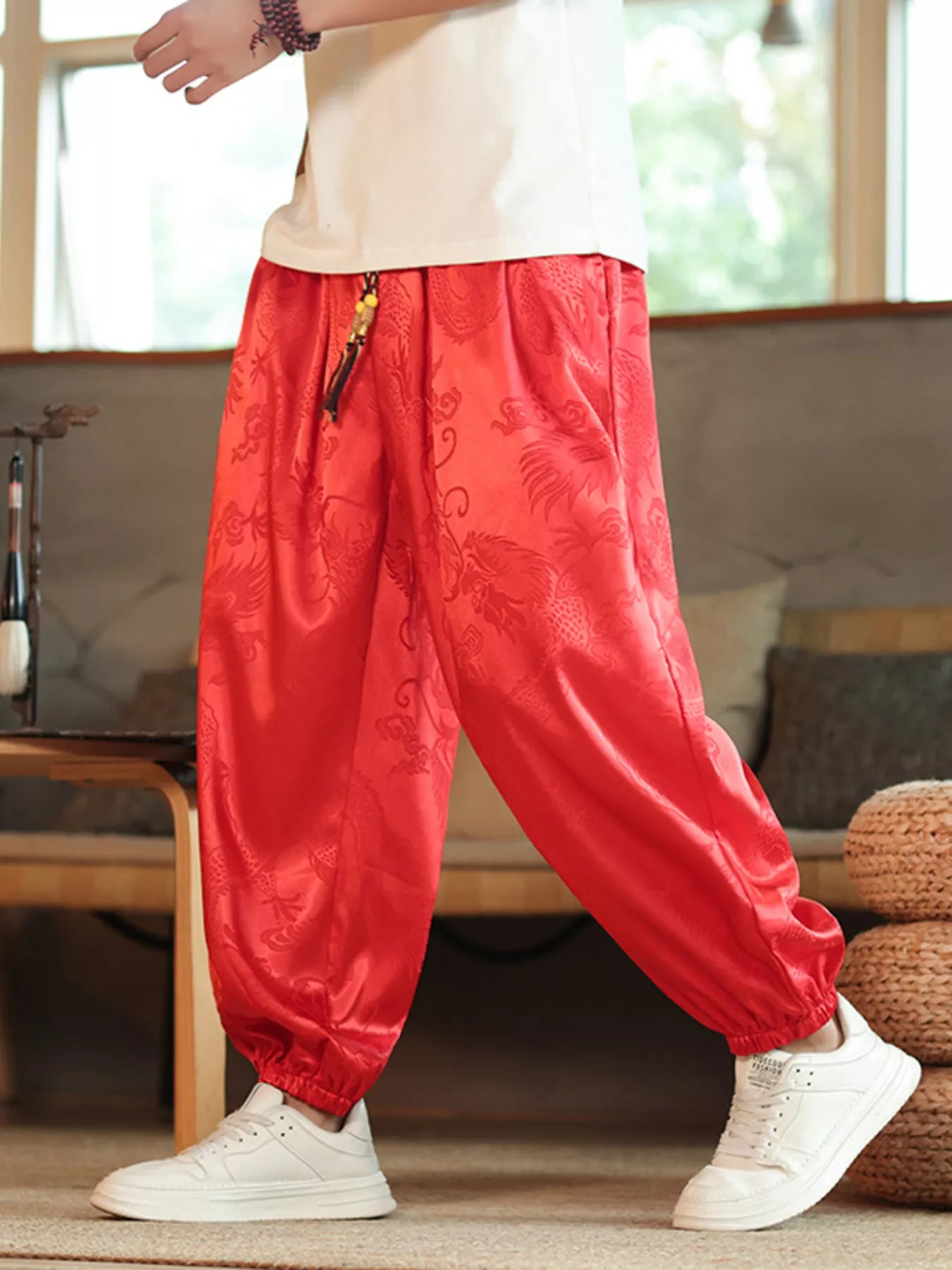 URBAN UNIT Dynasty Silhouette Jacquard Harem Pants in Blood Red. Oversized street-ready fit featuring tonal dragon patterns for the ultimate urban drape.