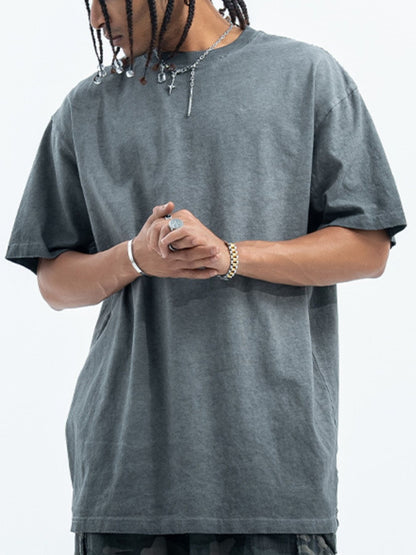 The essential URBAN UNIT Vintage Wash Tee in dark Asphalt Grey worn by a model, demonstrating the core foundation of the streetwear uniform.