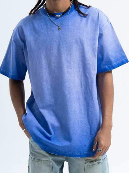 Male model wearing the oversized URBAN UNIT Essential Vintage Wash Tee in Faded Slate blue with a raw, lived-in aesthetic.