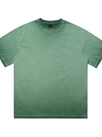 Flatlay of the URBAN UNIT Essential Vintage Wash Tee in Industrial Sage highlighting the raw acid-wash texture and structural wide cut.
