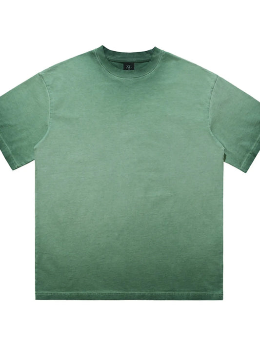 Flatlay of the URBAN UNIT Essential Vintage Wash Tee in Industrial Sage highlighting the raw acid-wash texture and structural wide cut.