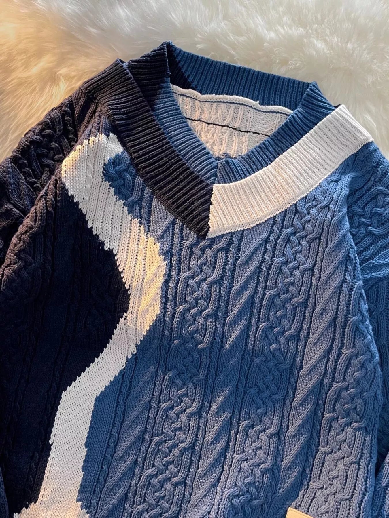 Close-up of the deep V-neck and heavy cable-knit texture on the URBAN UNIT Fracture Sweater in Deep Water Blue. Premium urban winter layering and structural design.