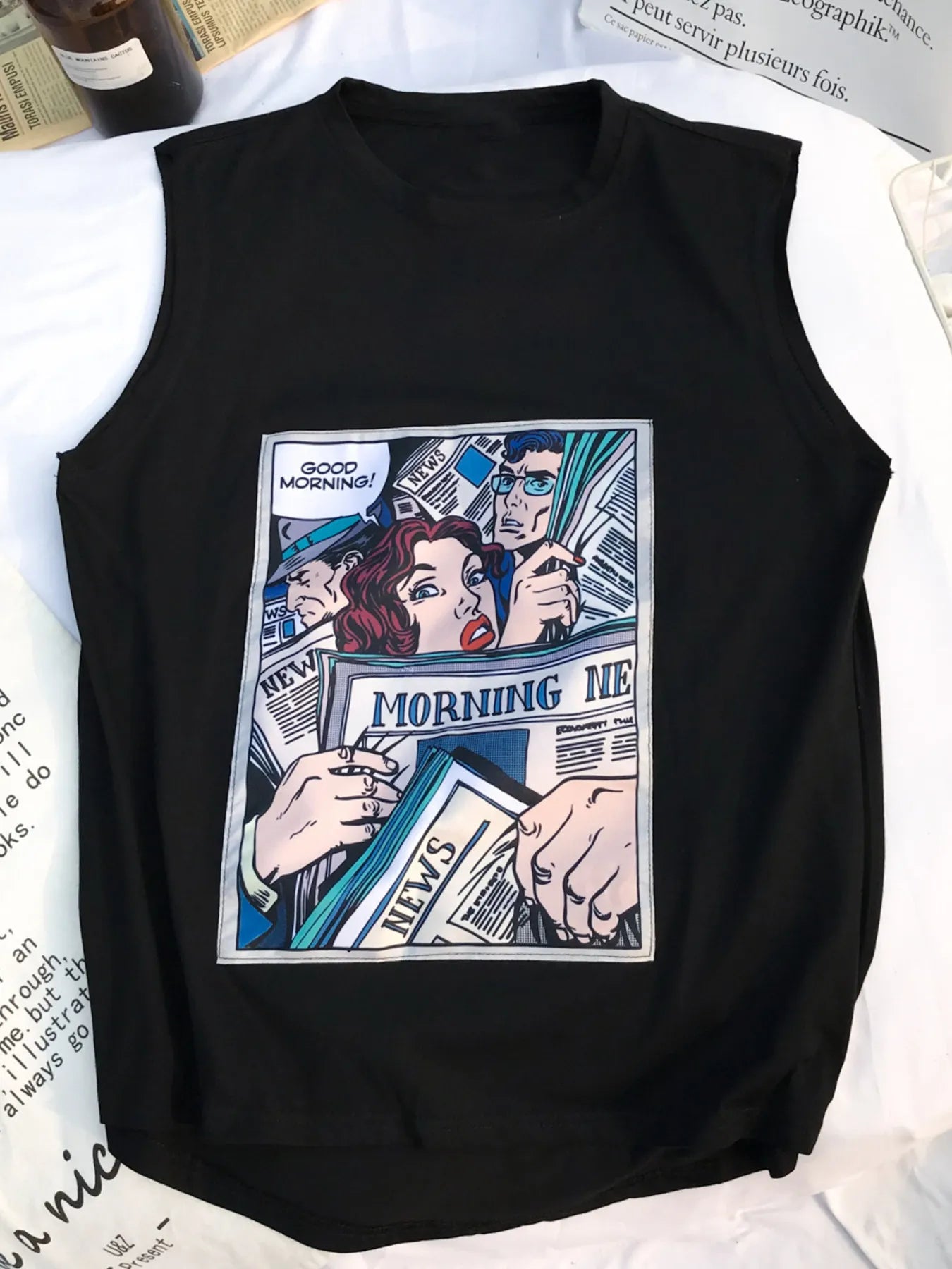 URBAN UNIT Morning News Graphic Tank in Midnight Black. Flat lay view featuring the bold comic graphic on a premium streetwear muscle shirt.