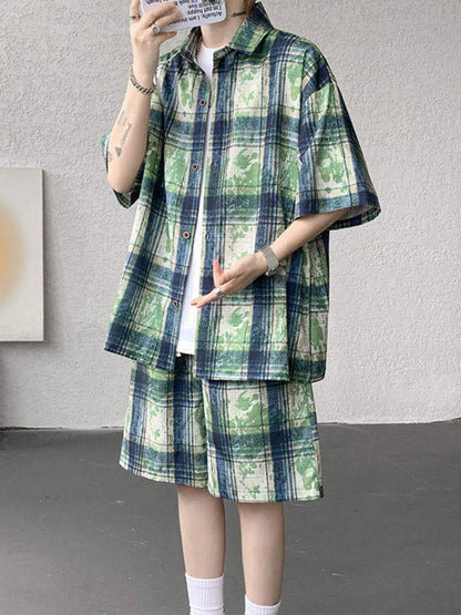 Male model wearing the URBAN UNIT OFF-GRID Plaid Set in Acid Turf. A green and navy industrial oversized matching shirt and shorts set.
