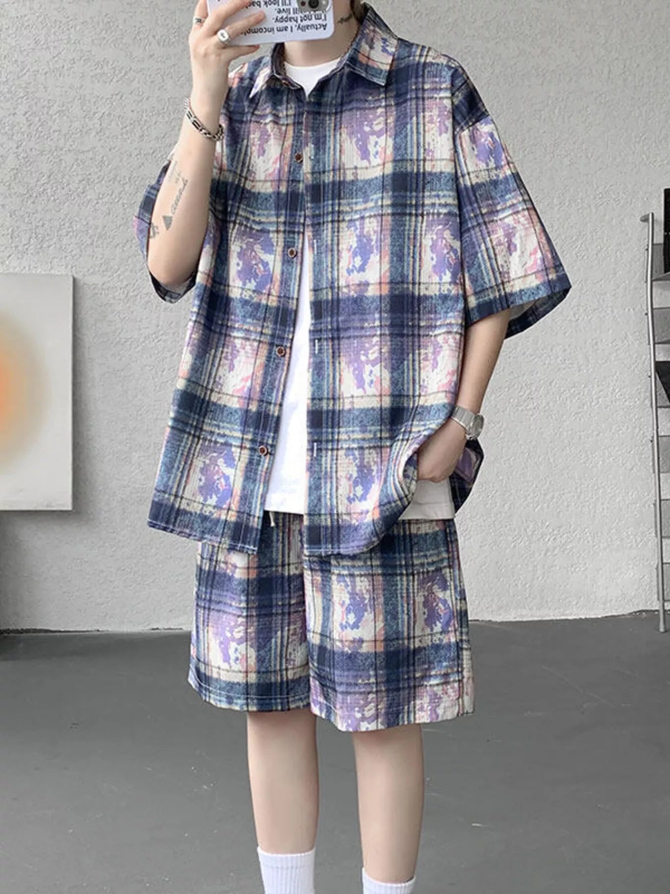 Male model wearing the URBAN UNIT OFF-GRID Plaid Set in Cobalt Phantom. A purple and blue oversized streetwear shirt and matching shorts co-ord.