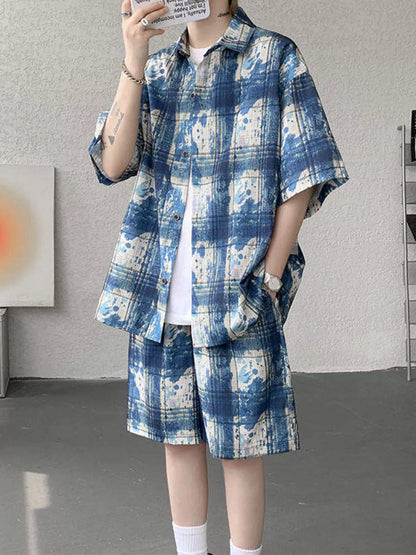 Male model wearing the URBAN UNIT OFF-GRID Plaid Set in Electric Blueprint. A blue and white high-contrast oversized summer streetwear outfit.