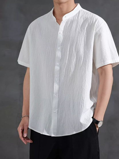 Model wearing the URBAN UNIT Origin Silhouette Mandarin Collar Shirt in Pure White. Premium oversized streetwear featuring a relaxed, plus-size optimized drape.
