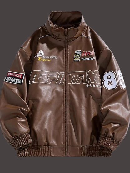 Front view of URBAN UNIT Racing Leatherette Shield in Brown - industrial aesthetic racing jacket with high-contrast white "85" numbering and technical patches.