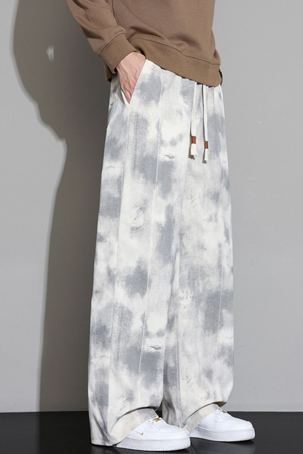 Angled view of the URBAN UNIT Static Wash Tie-Dye Pant in Concrete Static, demonstrating the fluid fabric blend and maximum mobility.
