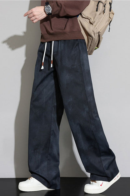 Side walking stance of the URBAN UNIT Static Wash Tie-Dye Pant in Phantom Wash, highlighting the fabric's flexibility and superior oversized drape in motion.