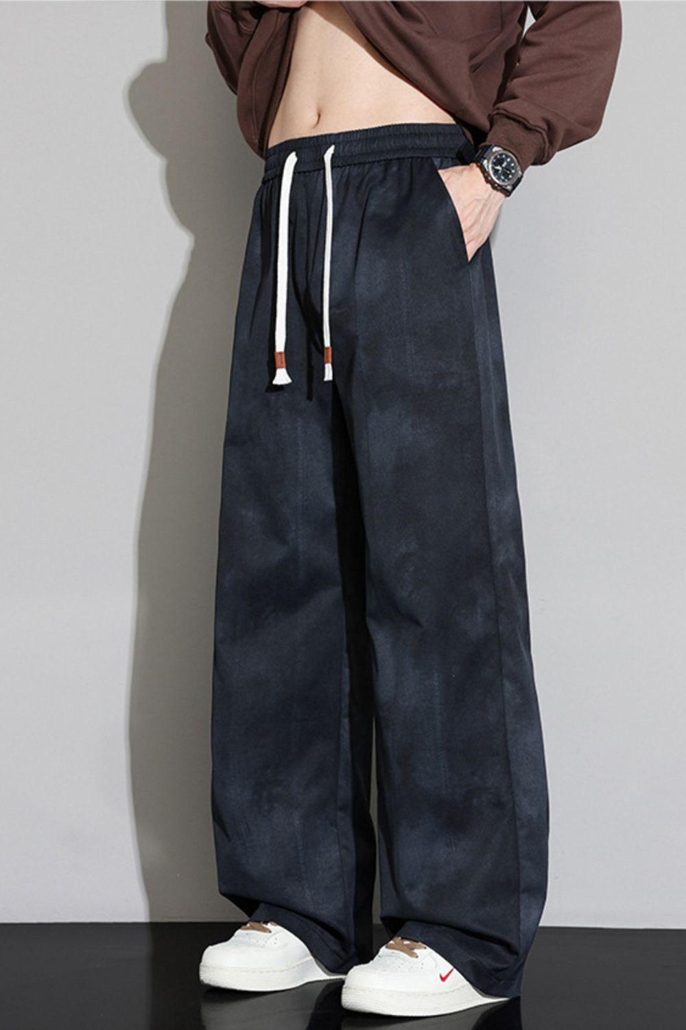 Model with hand in pocket wearing the URBAN UNIT Static Wash Pant in Phantom Wash, emphasizing the comfortable elastic waistband and street-ready fit.