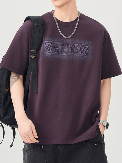 Model wearing the URBAN UNIT SUNDAY Origin Oversized Tee in Faded Plum with a backpack, showcasing the Plus Size Optimized streetwear drape and loose fit.