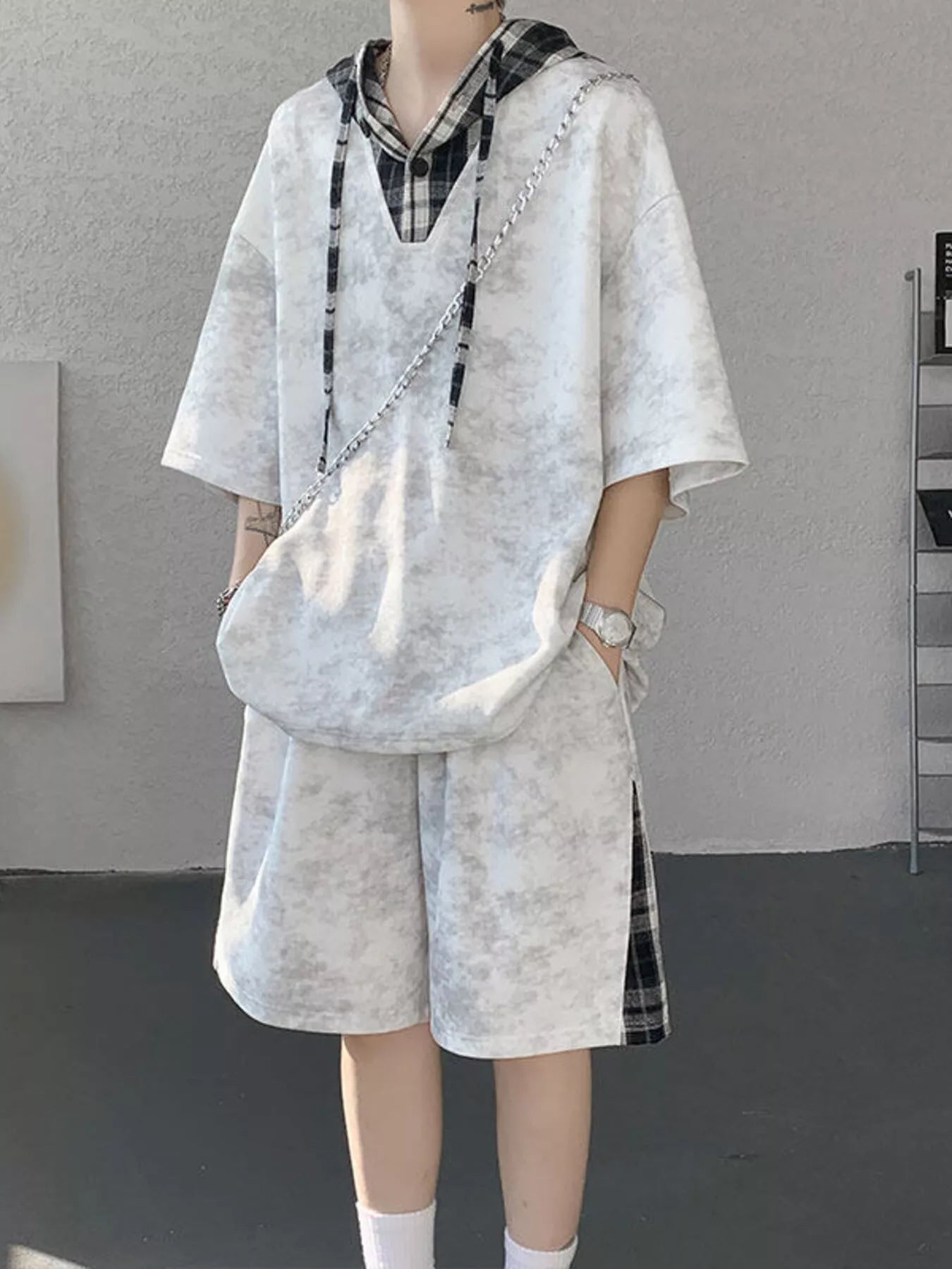 Front view of the URBAN UNIT VANGUARD Layered Set in Concrete Ash, featuring an oversized textured t-shirt hoodie and shorts with plaid accents.