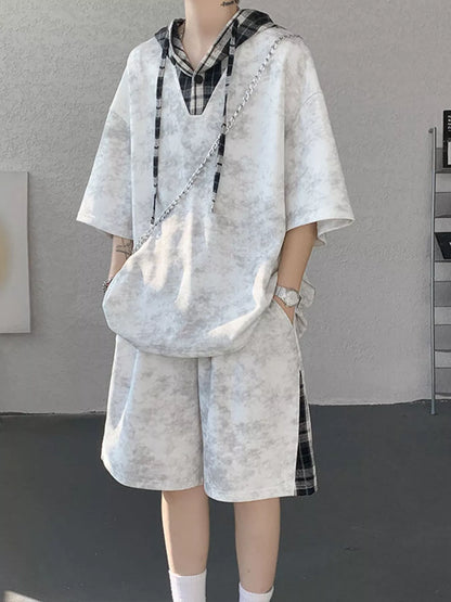Front view of the URBAN UNIT VANGUARD Layered Set in Concrete Ash, featuring an oversized textured t-shirt hoodie and shorts with plaid accents.