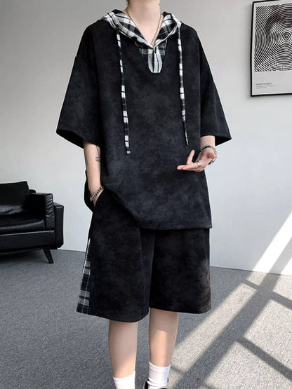 Front view of the URBAN UNIT VANGUARD Layered Set in Midnight Onyx, a black oversized streetwear two-piece with high-contrast plaid details.
