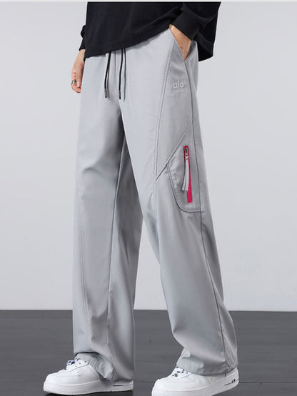 Model wearing UU Vector Zip Loose-Fit Cargo Pants in Concrete Grey. Industrial streetwear with maximum mobility by URBAN UNIT