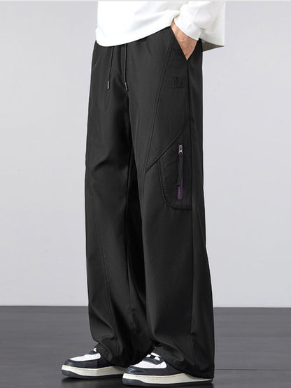 Model wearing UU Vector Zip Loose-Fit Cargo Pants in Midnight Black. Essential urban streetwear uniform by URBAN UNIT.