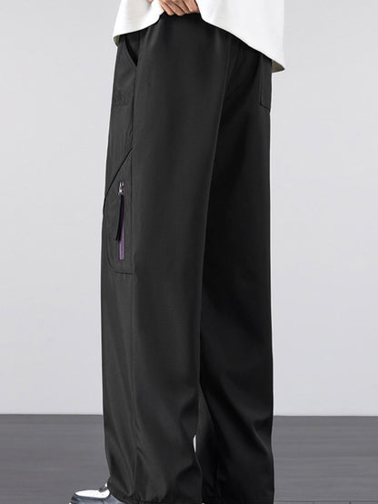 Side profile and deep pocket detail of the UU Vector Zip Loose-Fit Cargo Pants in Midnight Black by URBAN UNIT.