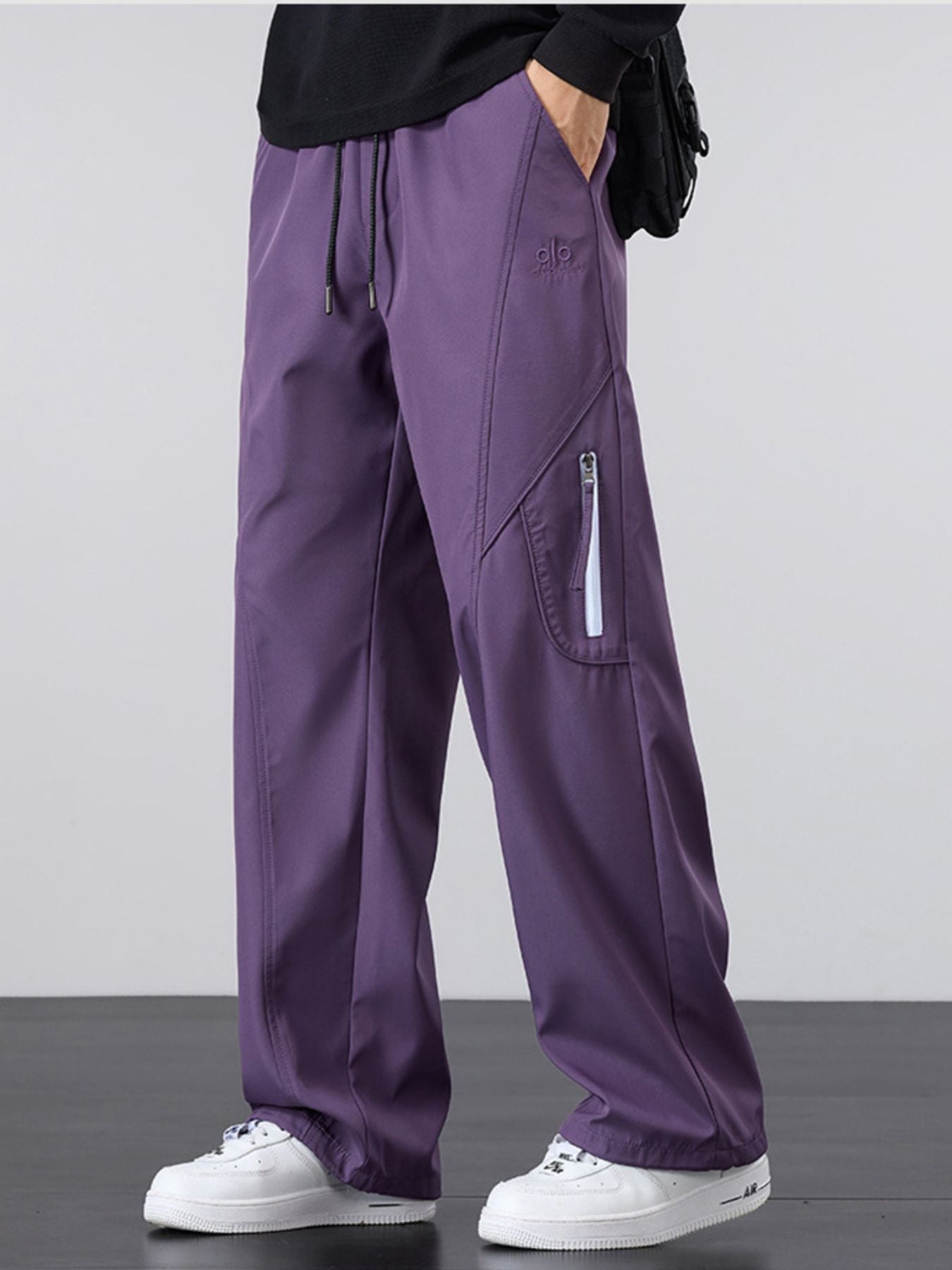 Model wearing UU Vector Zip Loose-Fit Cargo Pants in Shadow Violet. Premium oversized streetwear aesthetic with structural drape by URBAN UNIT.