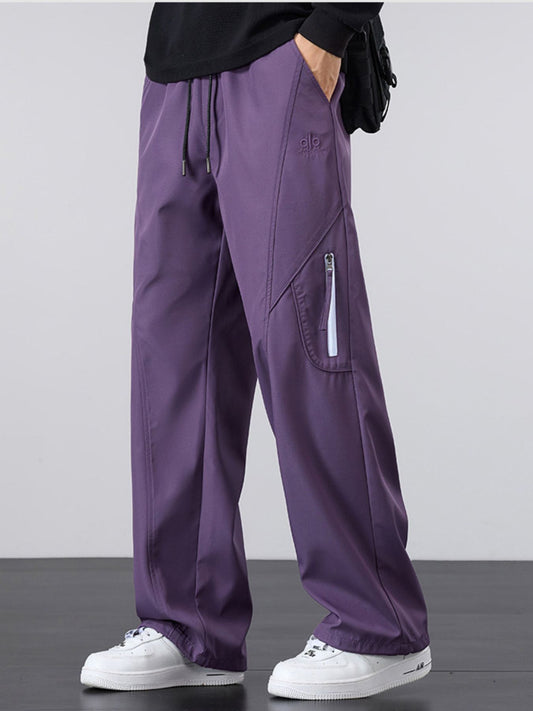 Model wearing UU Vector Zip Loose-Fit Cargo Pants in Shadow Violet. Premium oversized streetwear aesthetic with structural drape by URBAN UNIT.