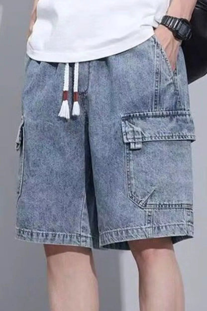 Model wearing URBAN UNIT Vintage Wash Cargo Denim Shorts in Washed Indigo. Demonstrating the wide-leg silhouette, plus size optimized drape, and heavy-duty pockets.