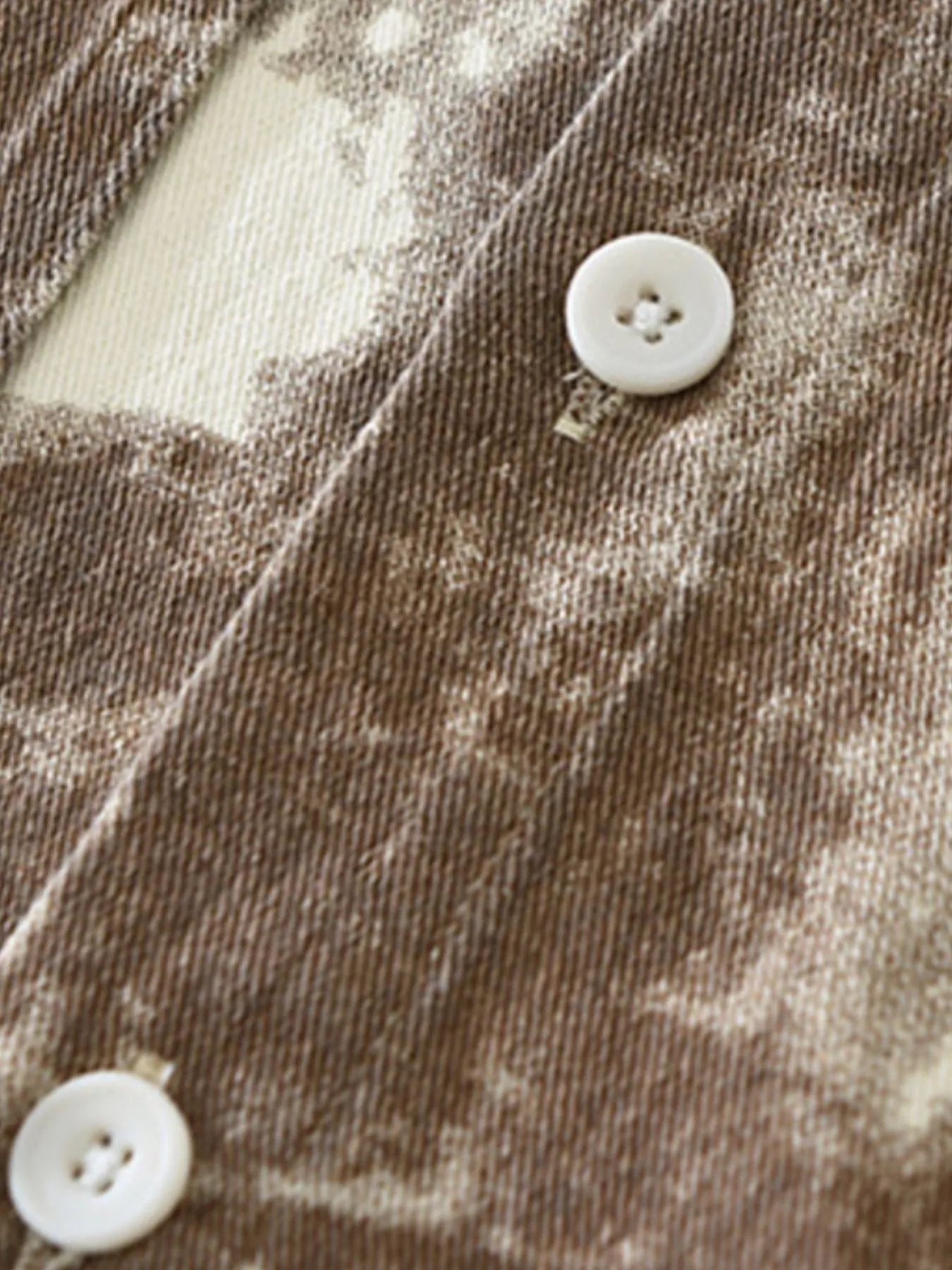 Close-up of the resilient cotton blend fabric and heavy-duty buttons on the URBAN UNIT Corrosion Oversized Shirt in Rust Terrain.