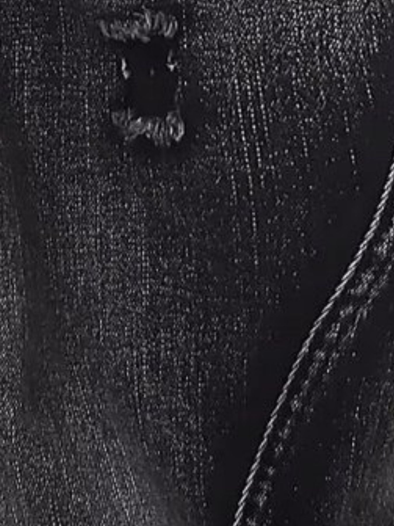 Close-up of heavy distressed detailing, frayed edges, and rigid 100% cotton texture on URBAN UNIT streetwear denim.