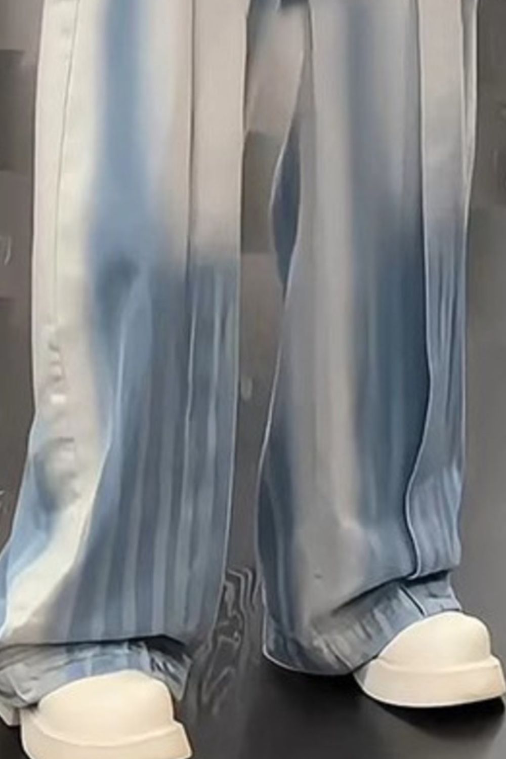 Close-up of the URBAN UNIT Gradient Wash Denim showcasing the wide-leg drape, raw blue fade, and structured fabric over chunky sneakers.