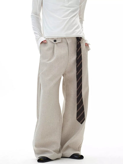 Front view of the URBAN UNIT Origin Silhouette Wide-Leg Trouser in Concrete Sand, showcasing the oversized drape and extended statement belt for a premium streetwear look.