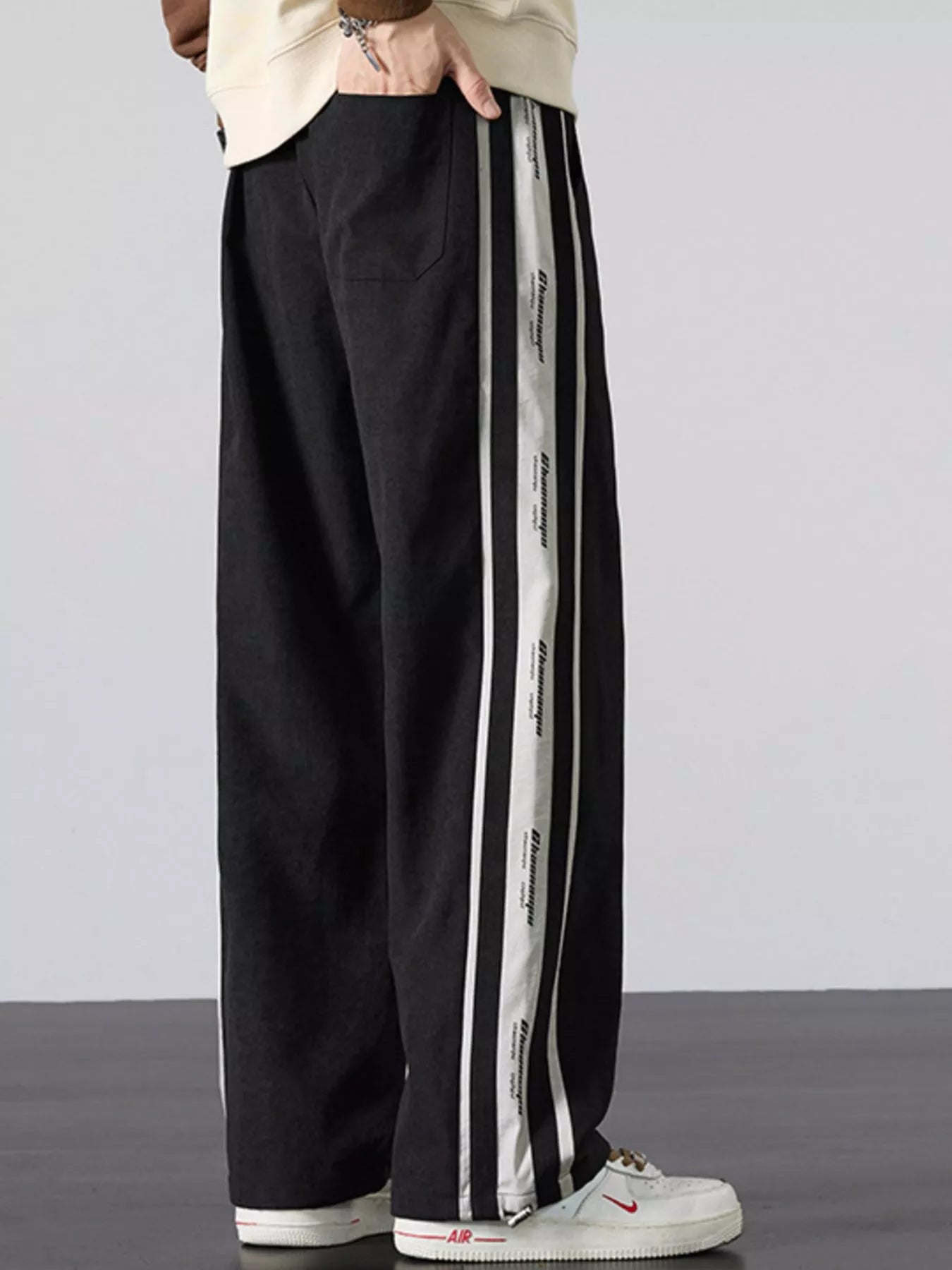 Side view showing the vertical stripe branding and oversized silhouette.