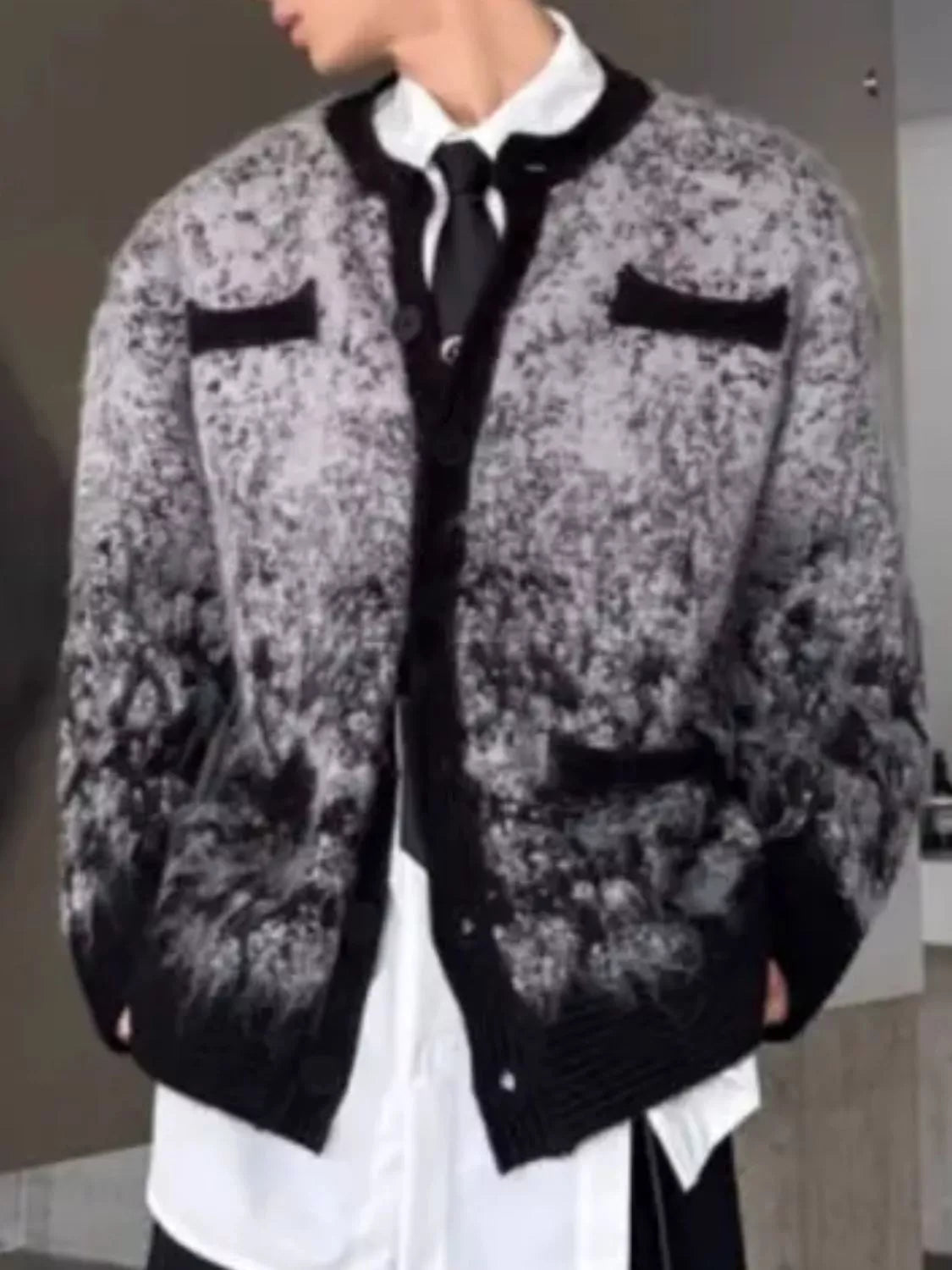 URBAN UNIT Static Gradient Knit Cardigan in Asphalt Gradient. Front view showcasing the raw, high-contrast textured pattern, dual pockets, and button-down fit.
