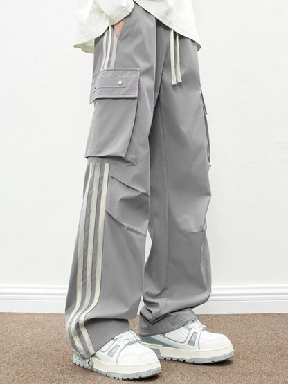 Front angle of the UU Vanguard Cargo in Ash Grey showing the oversized streetwear drape and white side panels.