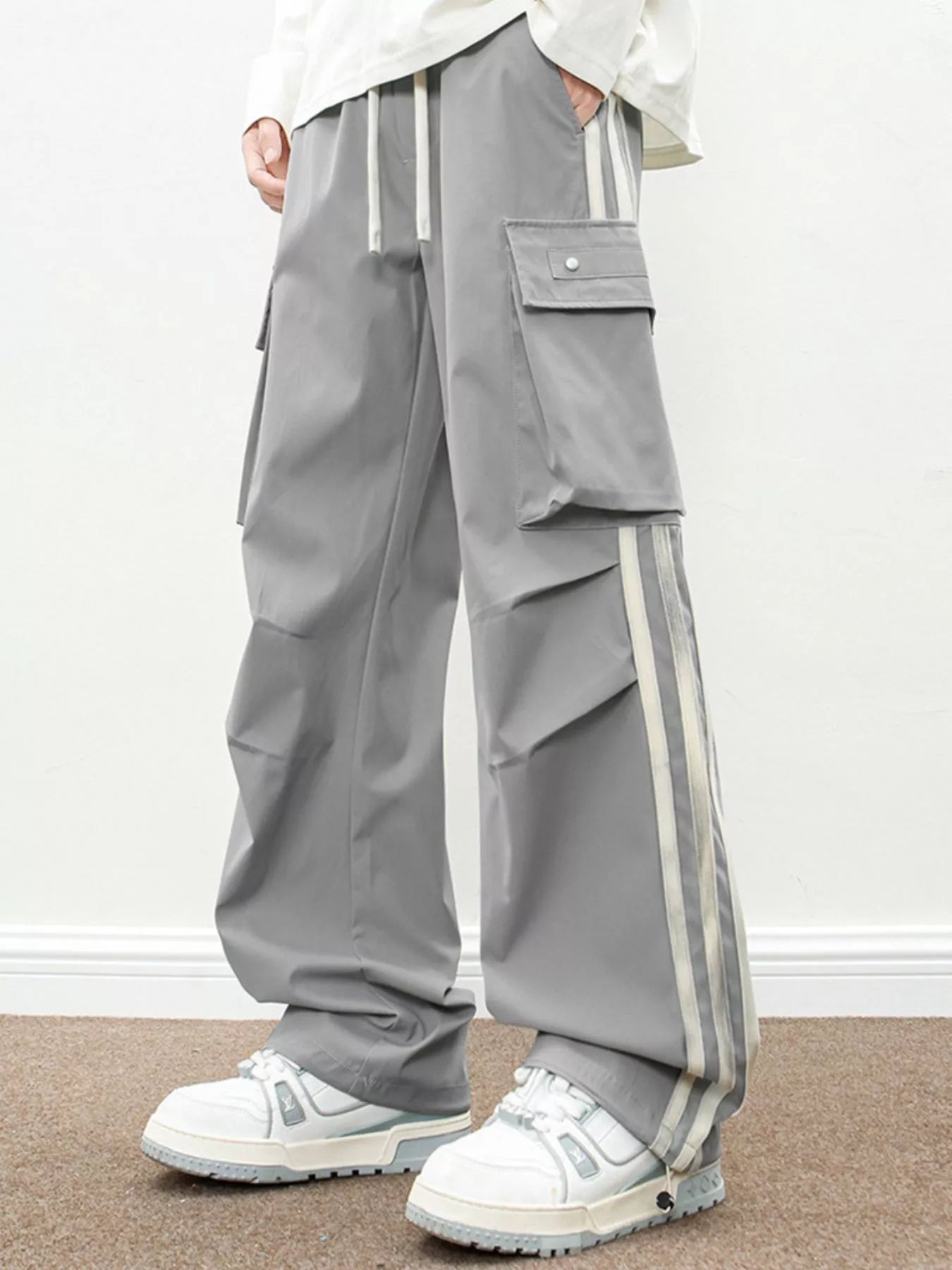 Urban Unit Vanguard Silhouette Wide-Leg Cargo Pants in Ash Grey with industrial side stripes and relaxed fit.