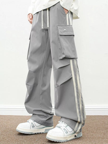 Urban Unit Vanguard Silhouette Wide-Leg Cargo Pants in Ash Grey with industrial side stripes and relaxed fit.