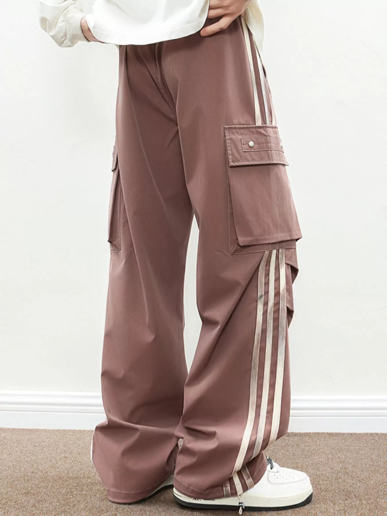 Detail shot of the side-stripes and functional cargo pockets on the Vanguard Silhouette Cargo in Oxide Brown.