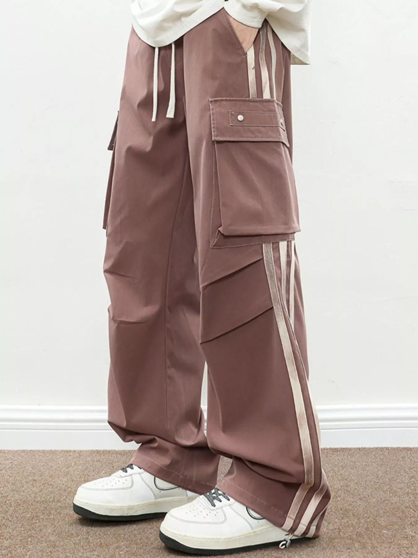Urban Unit Vanguard Silhouette Wide-Leg Cargo Pants in Oxide Brown with vertical side stripes and deep pockets.